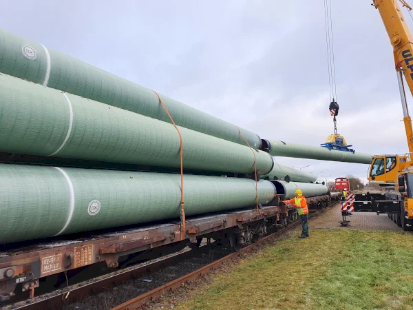 TDC GRP coated pipes being loaded onto a train for transportation to the jobsite