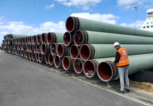 GRP coated pipes at a port ready to be transported via sea to the jobsite