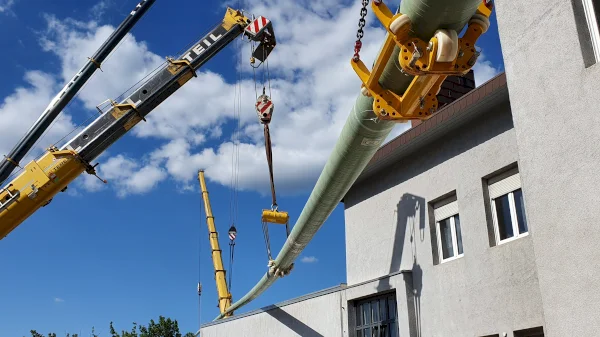 GRP coated pipeline being lifted over a building for a trenchless installation // TDC International