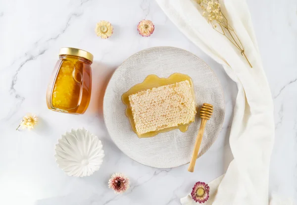 Honey with honey comb in jar. Cut comb honey 